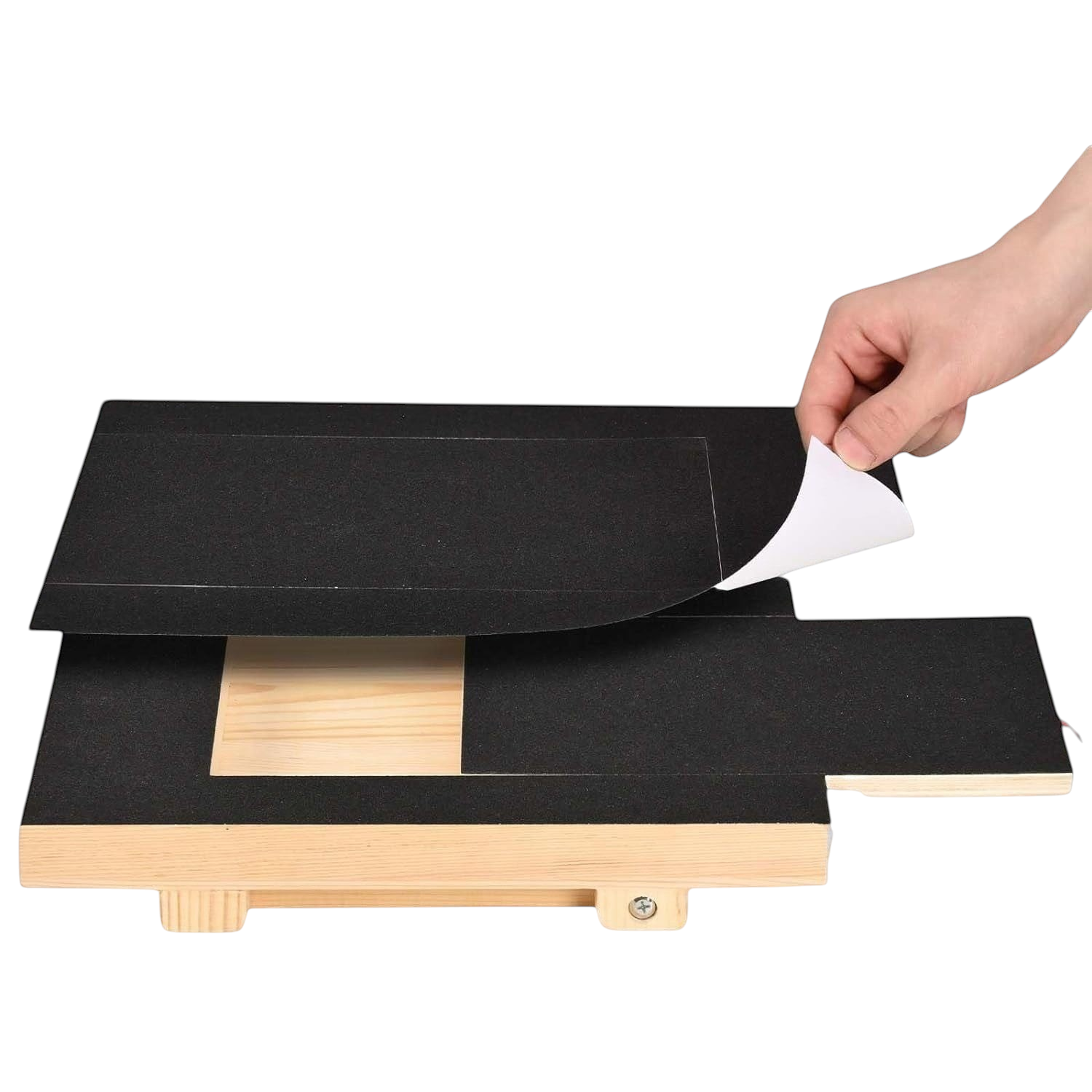 The Tailored Tail No-Shed Scratch Ramp with a hand peeling off the replaceable black sandpaper surface from wood base.